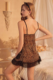 Woman wearing a leopard print Myvelvettouch nightgown in a softly lit room.