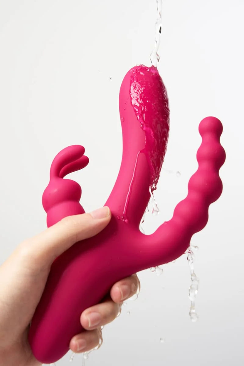 Pink silicone Myvelvettouch Dual Stimulation Rabbit Vibrator with Anal Beads and Vaginal Insertion held by a hand against a white background