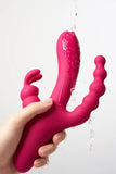Pink silicone Myvelvettouch Dual Stimulation Rabbit Vibrator with Anal Beads and Vaginal Insertion held by a hand against a white background