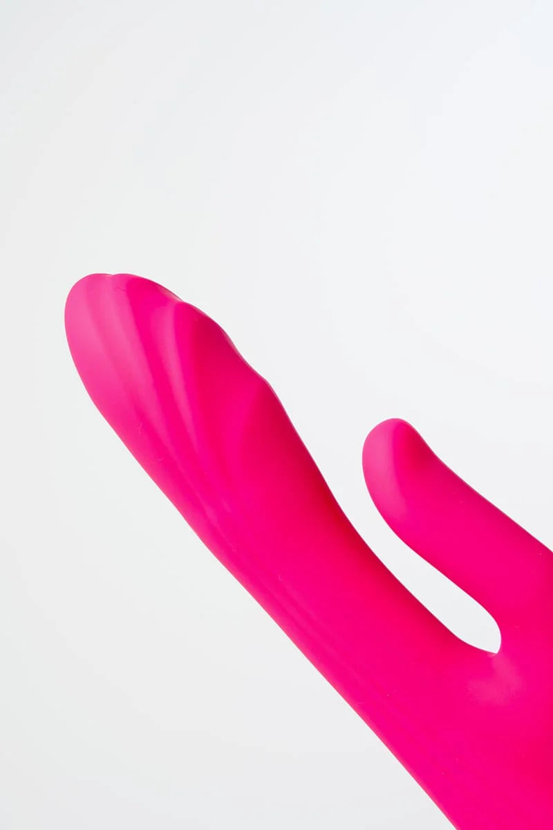 Close-up of a pink Myvelvettouch G-spot Tapping and Clitoral Stimulation Vibrator on a white background