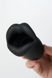 Black silicone Myvelvettouch Penis Trainer held by a hand on a white background