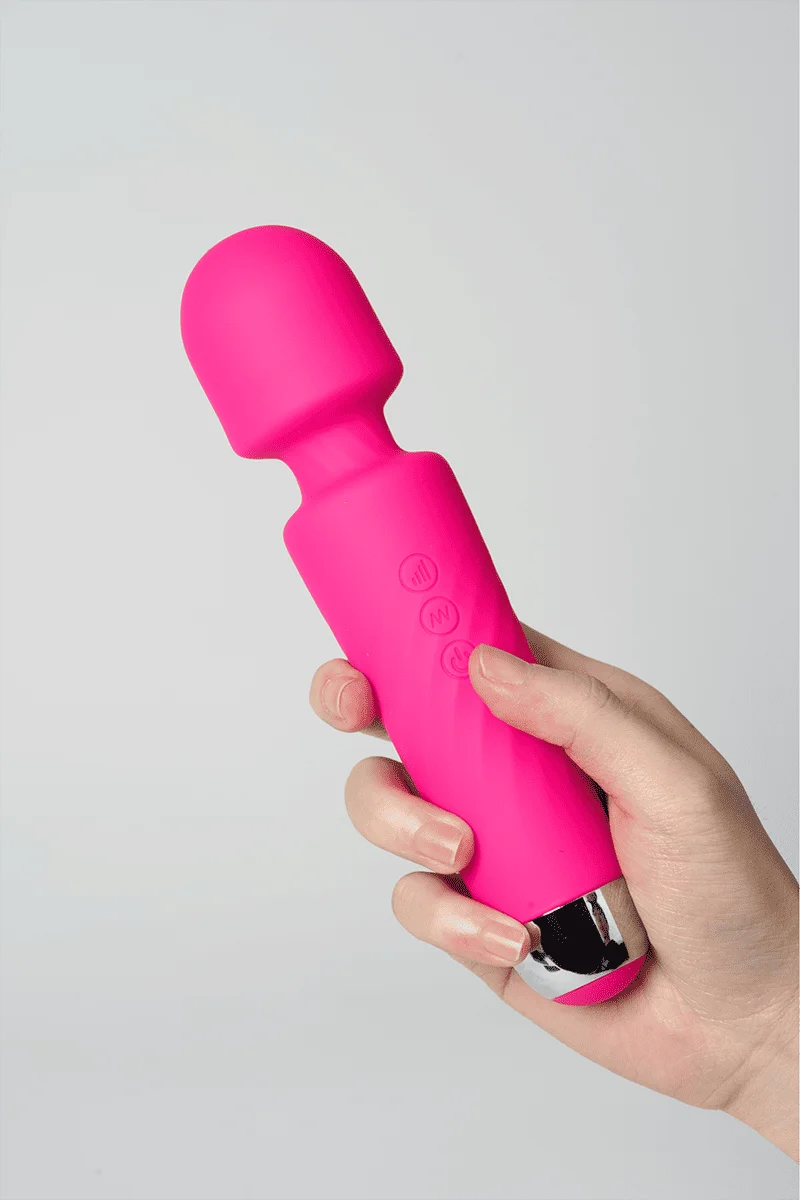 Myvelvettouch Portable Clitoral Stimulator Massager held by a hand on a light gray background