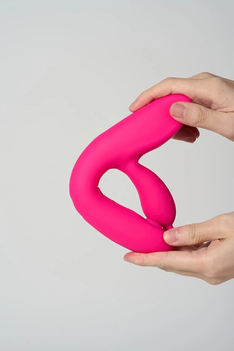 Pink Myvelvettouch Rabbit Clitoral Stimulation and G-spot Slapping Vibrator held by a hand against a light gray background