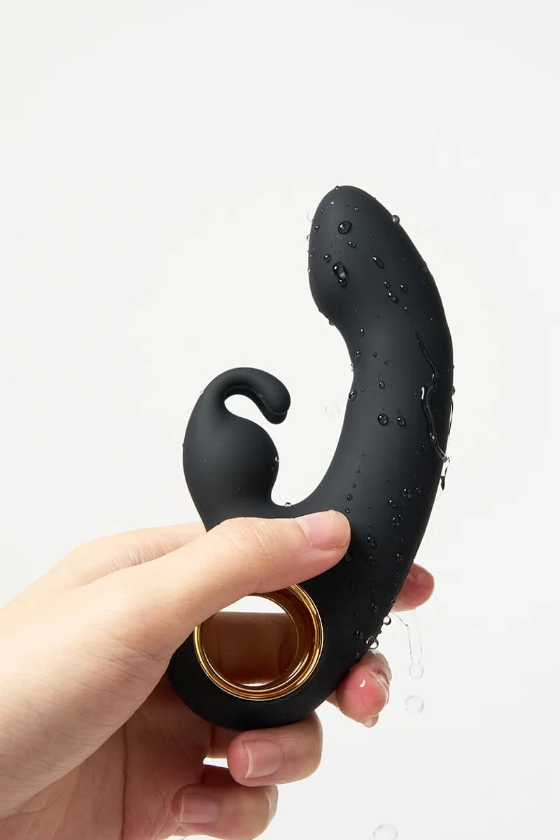 Black Myvelvettouch Rabbit Clitoral Stimulator and Finger G-spot Vibrator Massager held by a hand on a white background