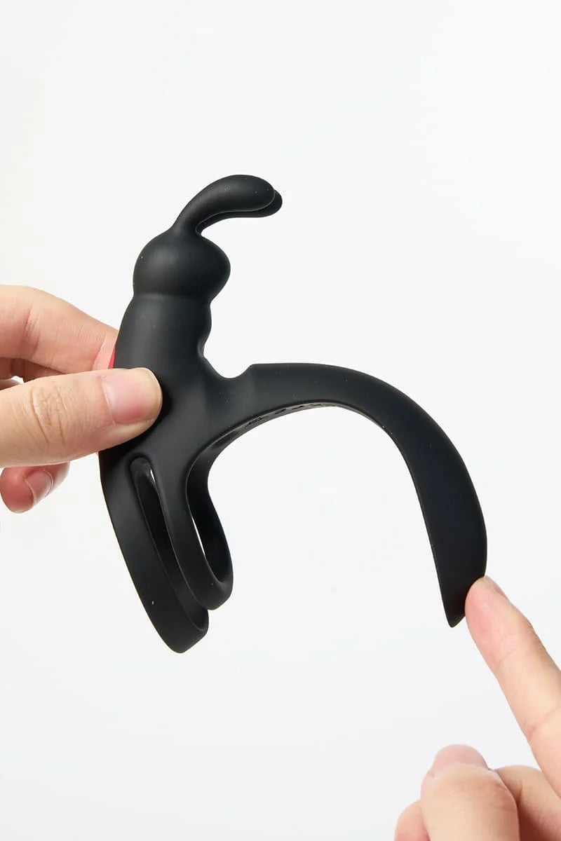 Black Myvelvettouch Rabbit Couple Vibrating Cock Ring held by a hand on a white background