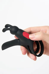 Black Myvelvettouch Rabbit Couple Vibrating Cock Ring held in a hand against a white background