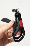 Black and red Myvelvettouch Rabbit Couple Vibrating Cock Ring with water droplets held by a hand against a white background