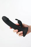 Black silicone Myvelvettouch Rabbit Suction Cup Dildo held by a hand on a white background