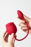 Myvelvettouch Rose 3-in-1 Sucking and Beating Egg Vibrator held by a hand on a white background