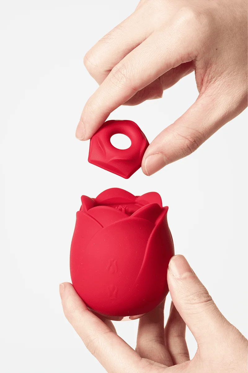 Myvelvettouch Rose Toy Clitoris Sucking and Slapping Massager with a hand holding it against a white background