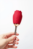 Myvelvettouch Rose Vibrator with Tongue Licking and Clitoral Stimulation with metal handle held by a hand on a white background