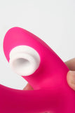 Pink and white Myvelvettouch Wearable Clitoral Sucking Vibrator with Vibration and Remote Control held in a hand against a white background