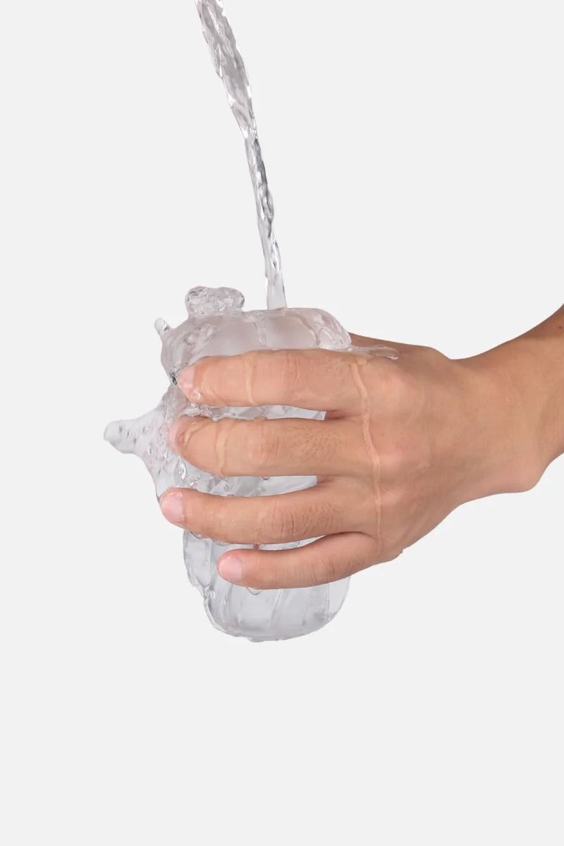 Hand washing a Suction Cup Automatic Sucking Vibration Voice Aircraft Cupwater on a white background