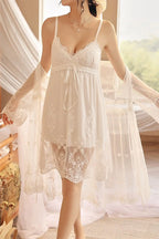 Woman wearing a white Myvelvettouch lace nightgown in a softly lit room.