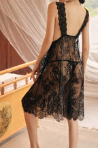 Black Myvelvettouch lace dress with a blurred background