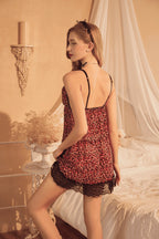 Woman in a leopard print Myvelvettouch nightgown standing in a bedroom setting.