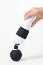 Hand holding a black and white Myvelvettouch Classic Japanese Movie Super Large AV Stick on a white background