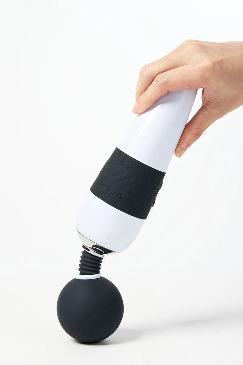 Hand holding a black and white Myvelvettouch Classic Japanese Movie Super Large AV Stick on a white background