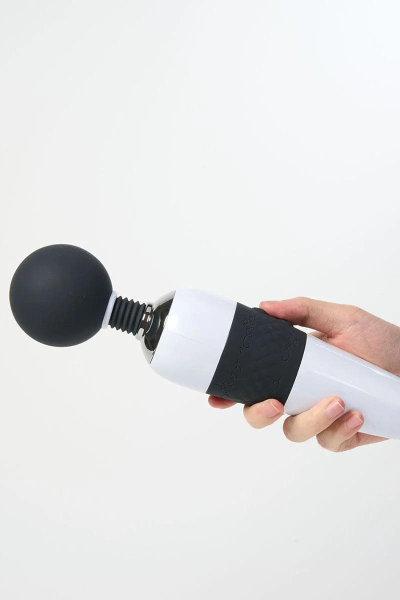 Hand holding a white and black Myvelvettouch Classic Japanese Movie Super Large AV Stick against a white background