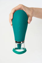 Myvelvettouch Clitoral Suction and Licking Vibrator held by a hand on a light gray background