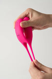 Pink Myvelvettouch Cock Ring and Remote Control Couple Vibrator held by hands against a white background