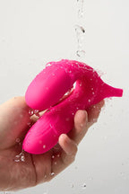 Pink Myvelvettouch Cock Ring and Remote Control Couple Vibrator being inflated underwater with water droplets visible