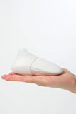 White Myvelvettouch Colorful Clitoral Slapping Massager held in a hand against a white background