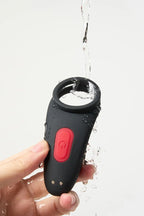 Black and red Myvelvettouch Couples Vibrating Ring with Remote Control being rinsed under water with a white background