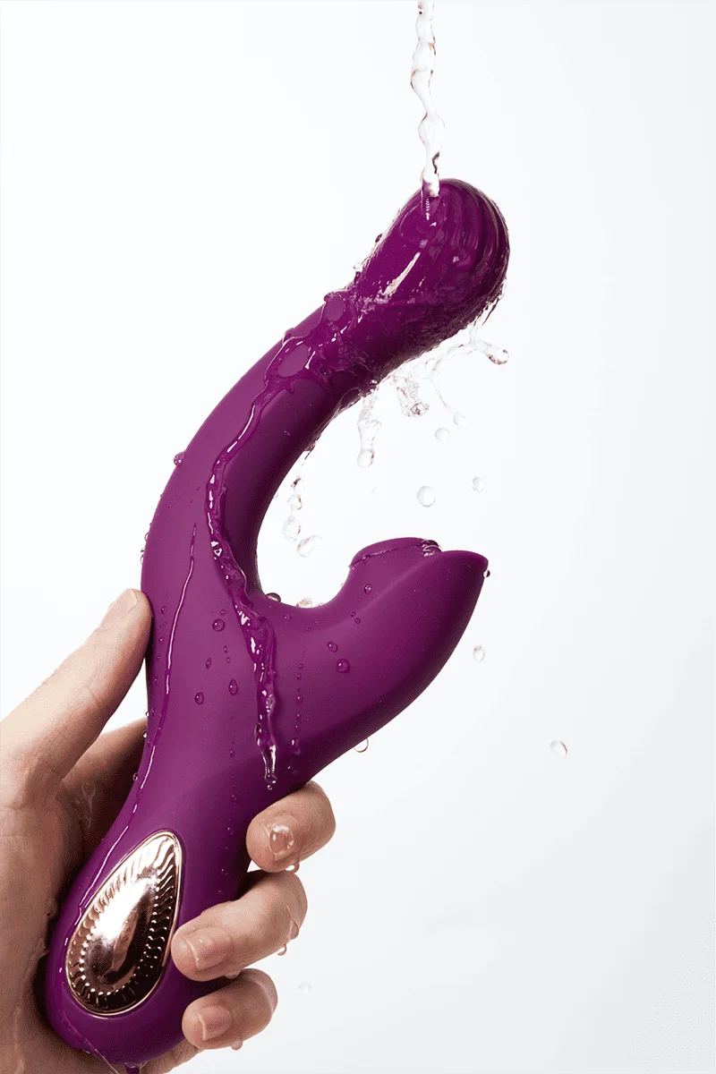 Myvelvettouch Elegant Purple G-Spot and Clitoral Sucking Vibrator 2-in-1 with water droplets held by a hand against a white background
