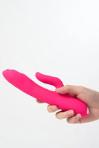 Hand holding a pink Myvelvettouch G-spot Tapping and Clitoral Stimulation Vibrator against a white background