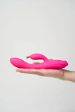 Pink Myvelvettouch Heated Rabbit Vibrator held in a hand against a light gray background