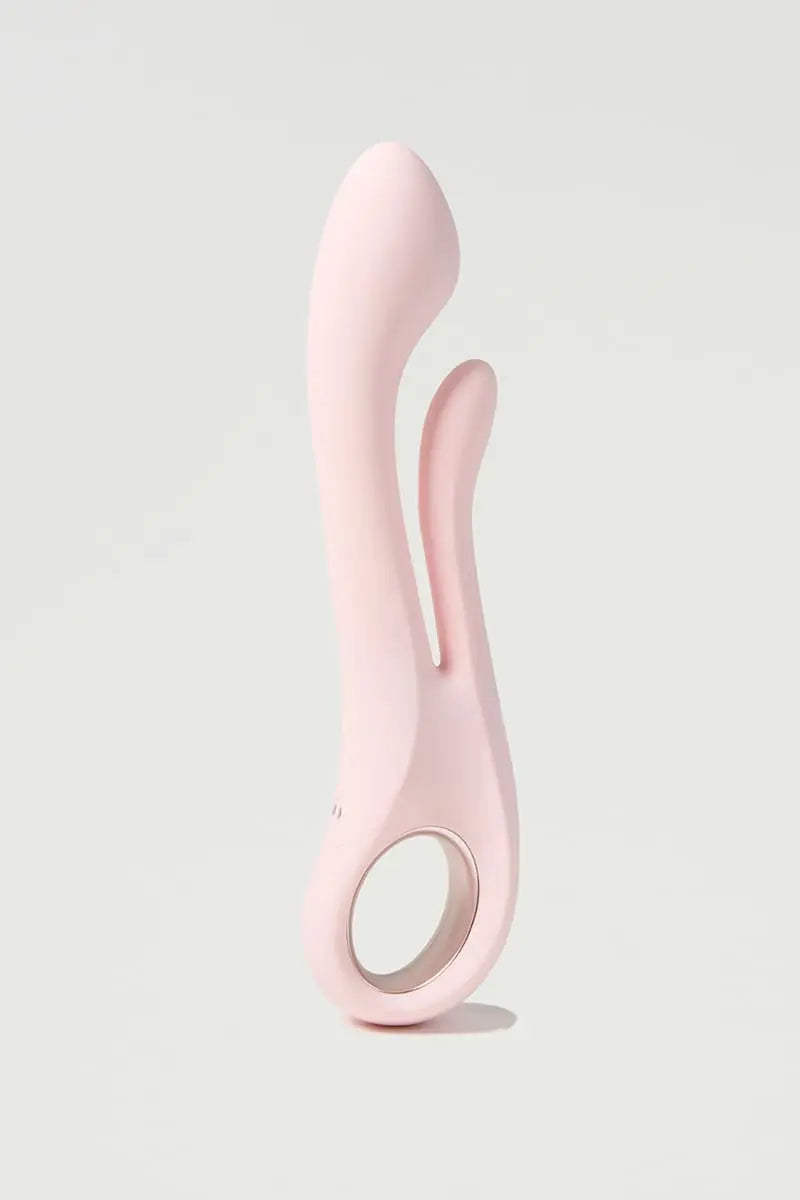 Pink silicone Myvelvettouch Multifunctional Clitoral Stimulator Dual Head Vibrator on a light gray background