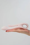 Pink Myvelvettouch Multifunctional Clitoral Stimulator Dual Head Vibrator held in a hand against a light gray background