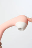 White silicone Myvelvettouch Portable 2-in-1 Female Sucking and Vibrator against a light gray background