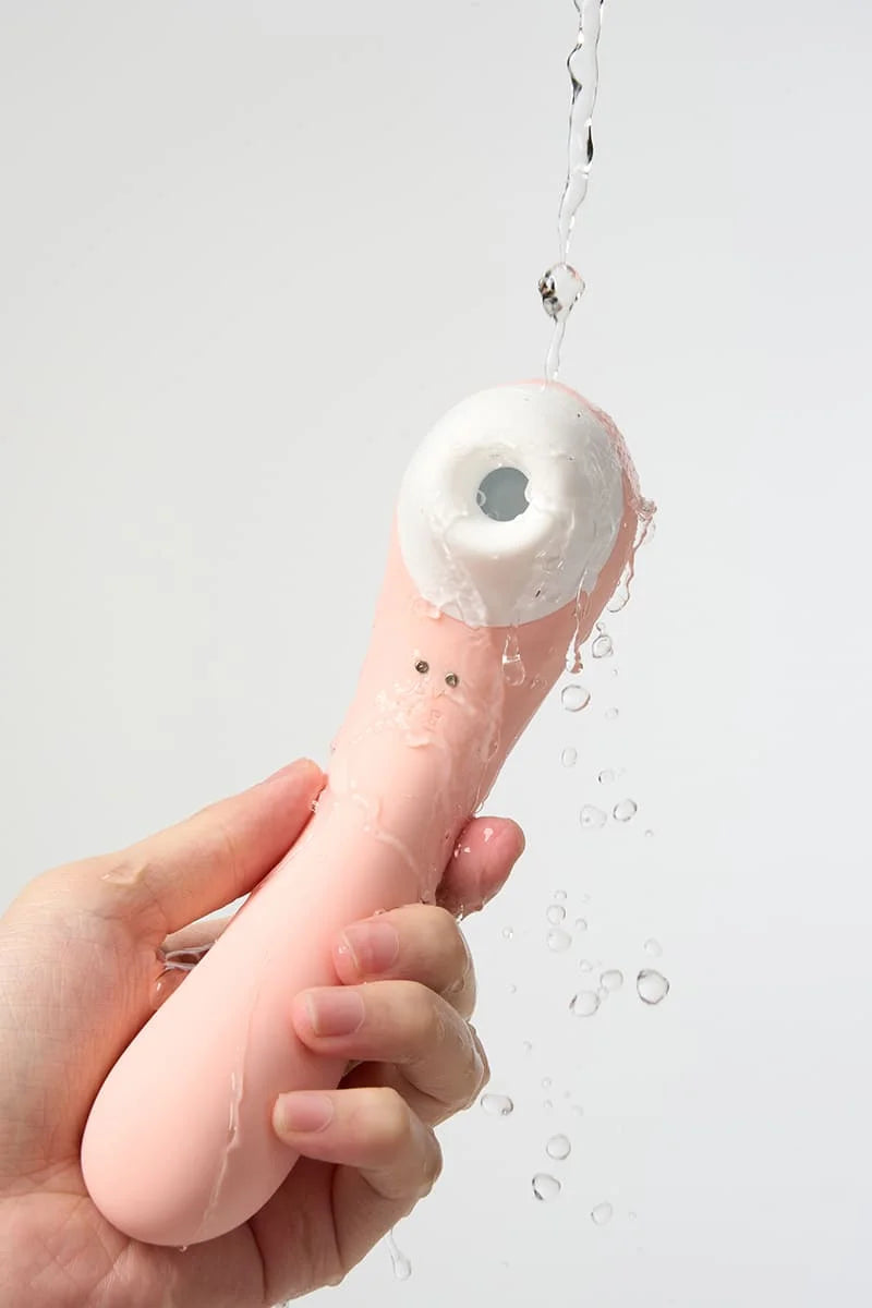 Hand holding a silicone Myvelvettouch Portable 2-in-1 Female Sucking and Vibrator against a light background