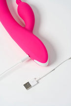 Pink Myvelvettouch Rabbit Clitoral Stimulation and G-spot Slapping Vibrator with USB charger on a white background