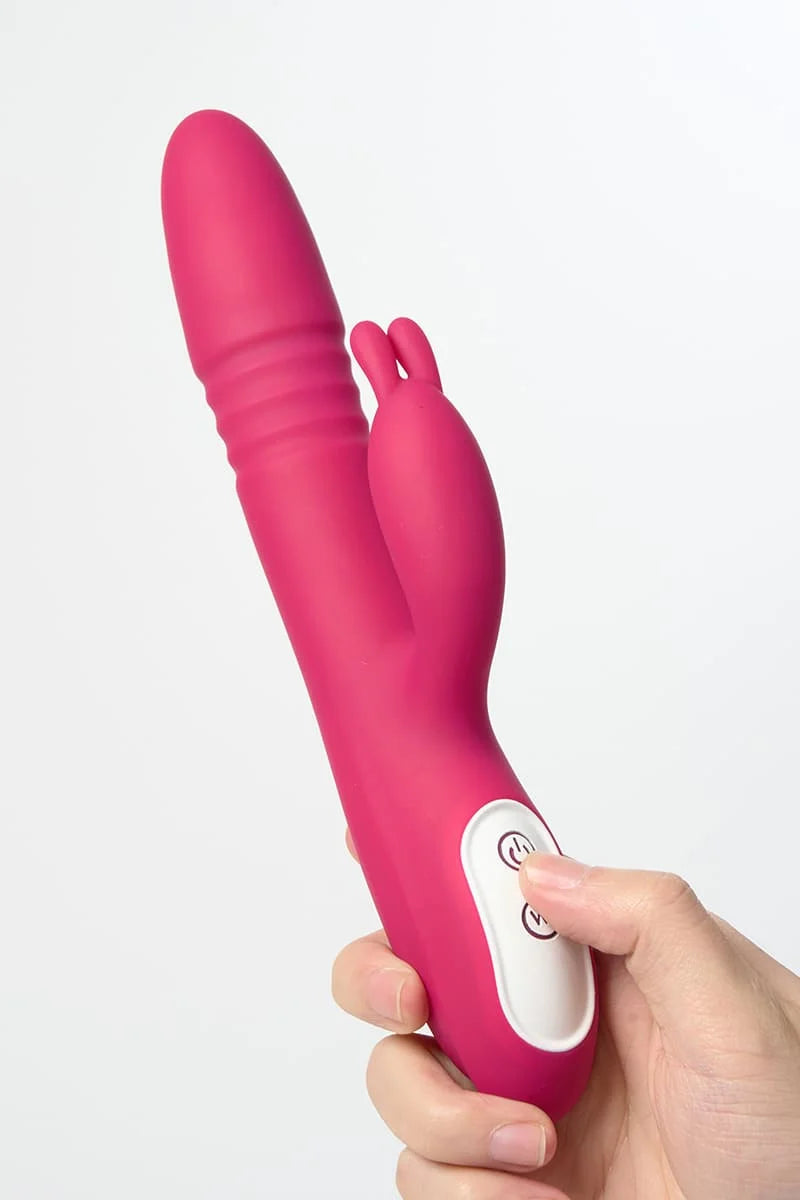 Pink Myvelvettouch Rabbit Clitoral Stimulator and Thrusting Vibrator held by a hand on a white background
