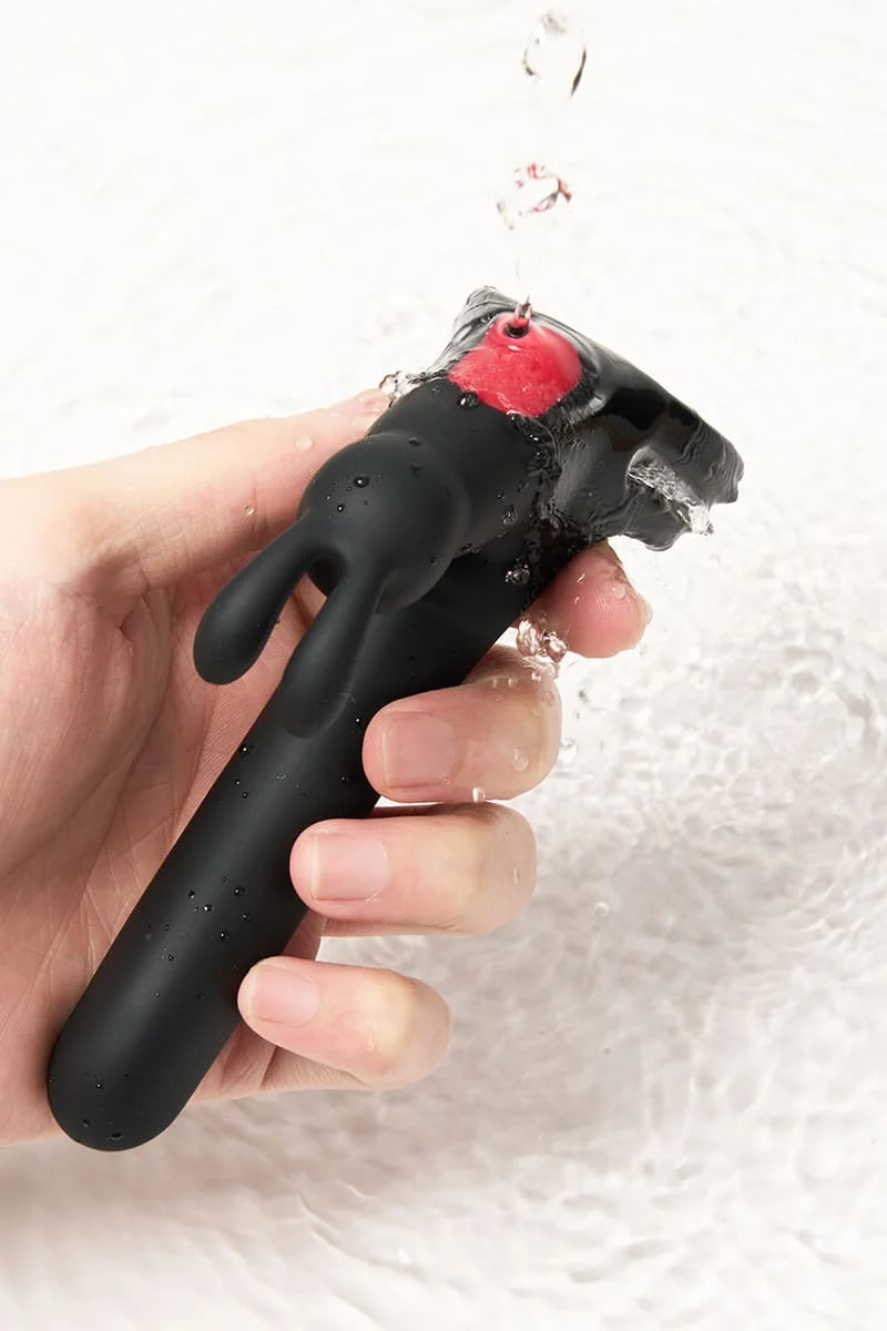 Black and red Myvelvettouch Rabbit Couple Vibrating Cock Ring being used on a white background