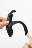 Black Myvelvettouch Rabbit Couple Vibrating Cock Ring held by a hand on a white background