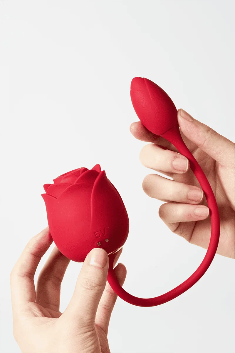 Myvelvettouch Rose 3-in-1 Sucking and Beating Egg Vibrator held by a hand on a white background