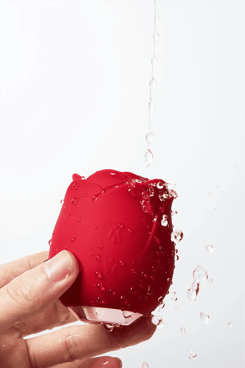 Myvelvettouch Rose Toy Clitoris Sucking and Slapping Massager being held under water with a white background