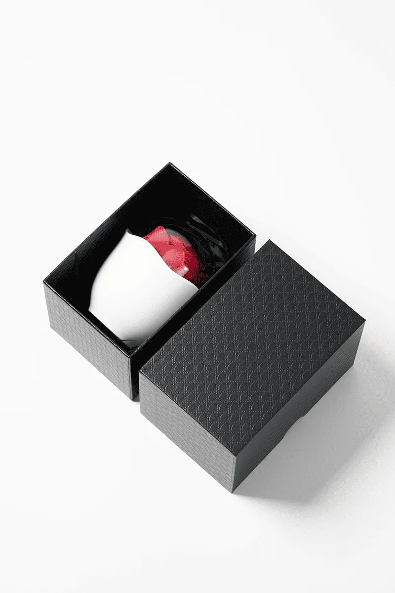 Black textured box with a Myvelvettouch Rose Pot Clitoral Sucking and Slapping Stimulator inside on a white background