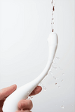 Myvelvettouch Swan Neck G-spot Stimulator Vibrator held by a hand with water splashes on a white background