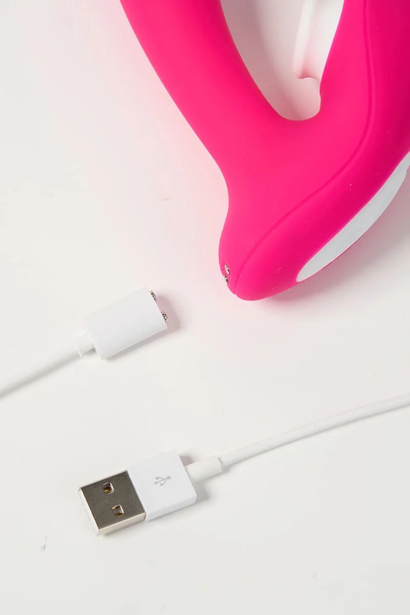 Pink Myvelvettouch Wearable Clitoral Sucking Vibrator with Vibration and Remote Control with a USB cable on a white background