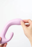 Hand holding a pink silicone Myvelvettouch Rabbit 3-in-1 Tapping and Sucking Vibrator against a white background