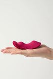 Hand holding a pink Myvelvettouch Remote control sex toys Panty Vibrator against a white background
