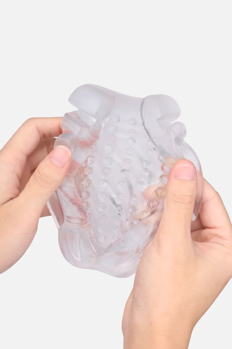 Clear silicone containter of Suction Cup Automatic Sucking Vibration Voice Aircraft Cup held by two hands on a white background