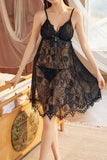 Woman wearing a black Myvelvettouch lace nightgown in a softly lit room.