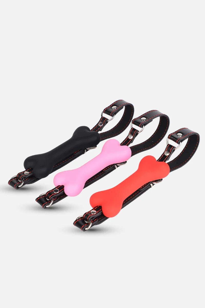 Silicone Bone Gag with Adjustable Strap in black, pink, and red on a white background
